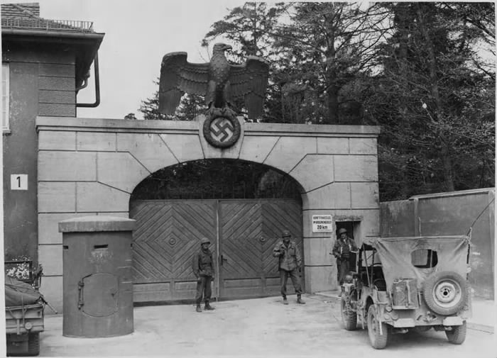 American soldiers at the gate of Dachau on the day of its liberation, the post the 42nd Rainbow Division held, April 1945