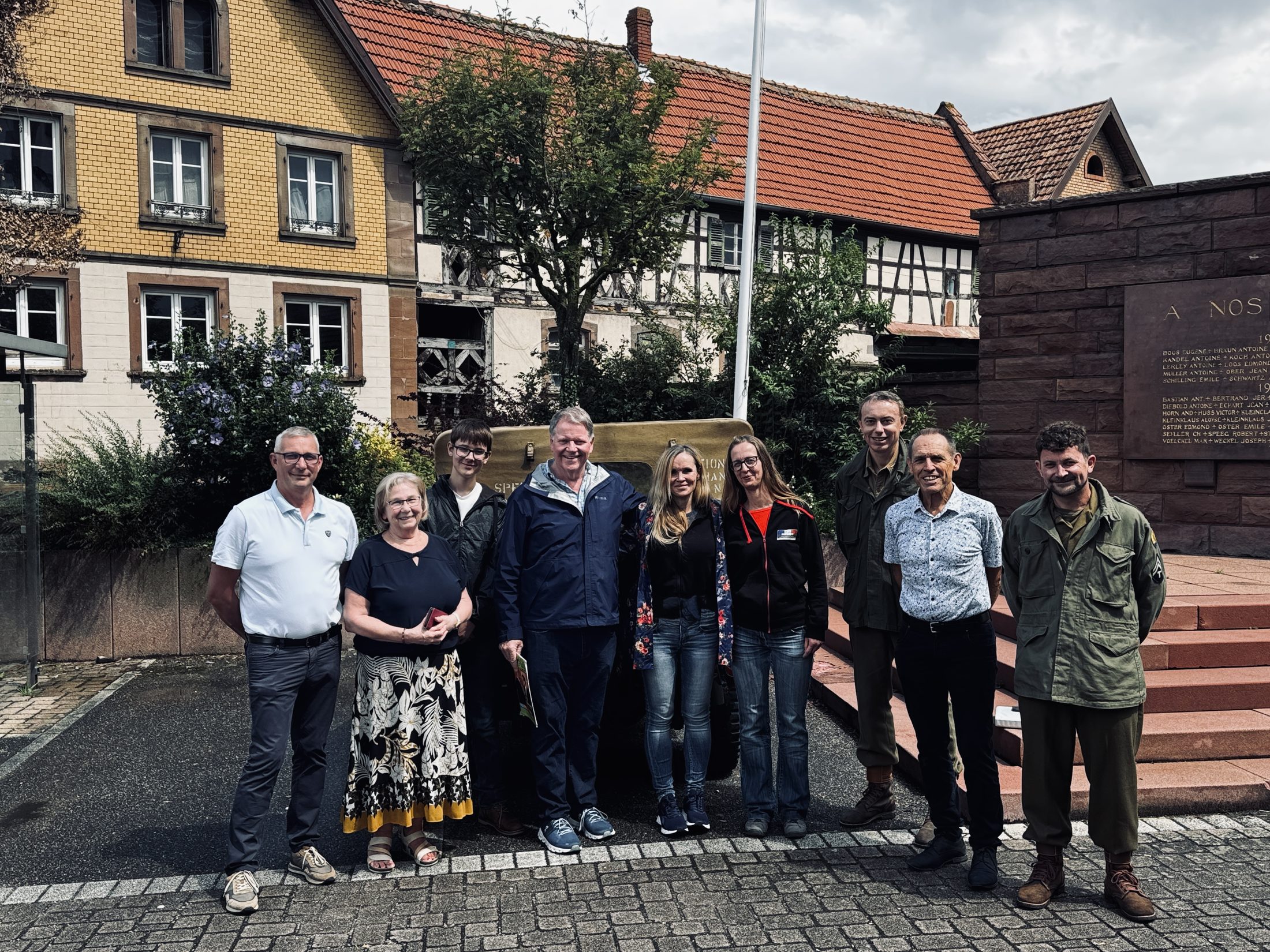 Historian Erin Faith Allen with a 42nd Rainbow Division family at the memorial in Dauendorf, Alsace